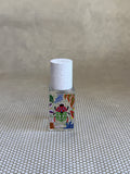 small bottle of maison matine perfume with beetle drawing design on bottle. 