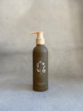 brown pump bottle of My Neighbor's wild bergamot hand wash with floral design. 