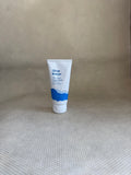 Ursa Major fantastic face wash traveler tube on a textured beige surface