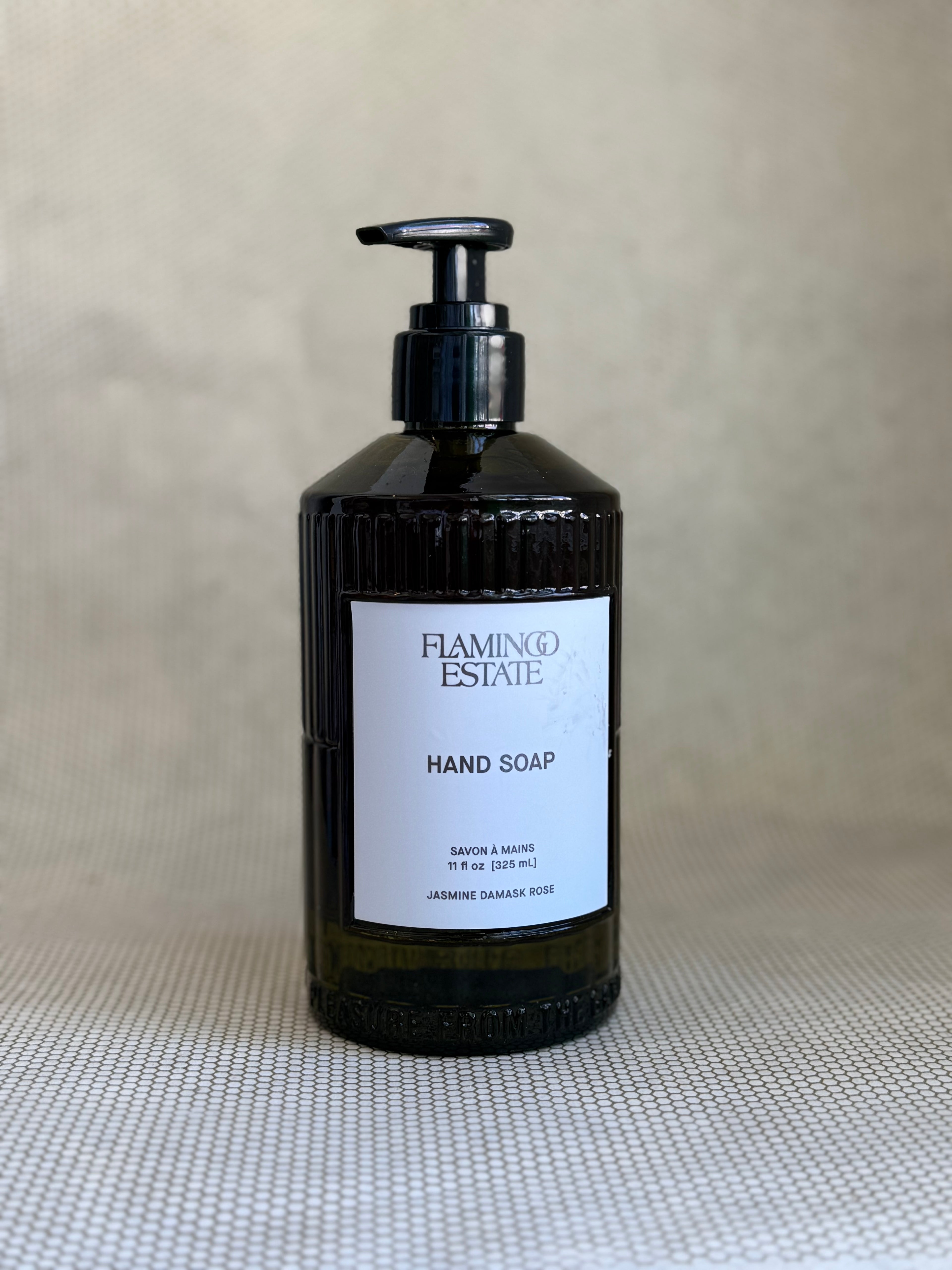 dark green glass pump bottle of flamingo estate hand soap jasmine damask rose