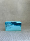 Ursa Major Hoppin' Fresh Bar Soap packaging on a textured surface