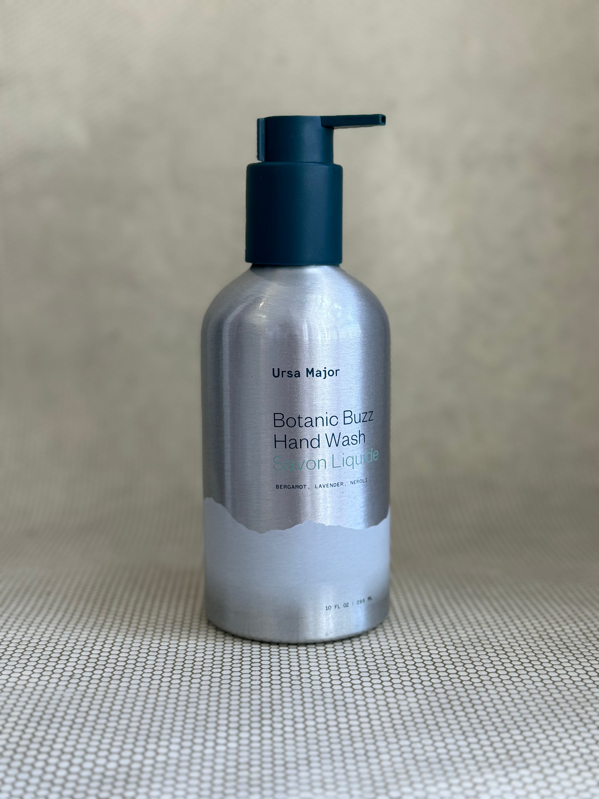 silver metallic pump bottle of Ursa Major Botanic Buzz Hand Wash
