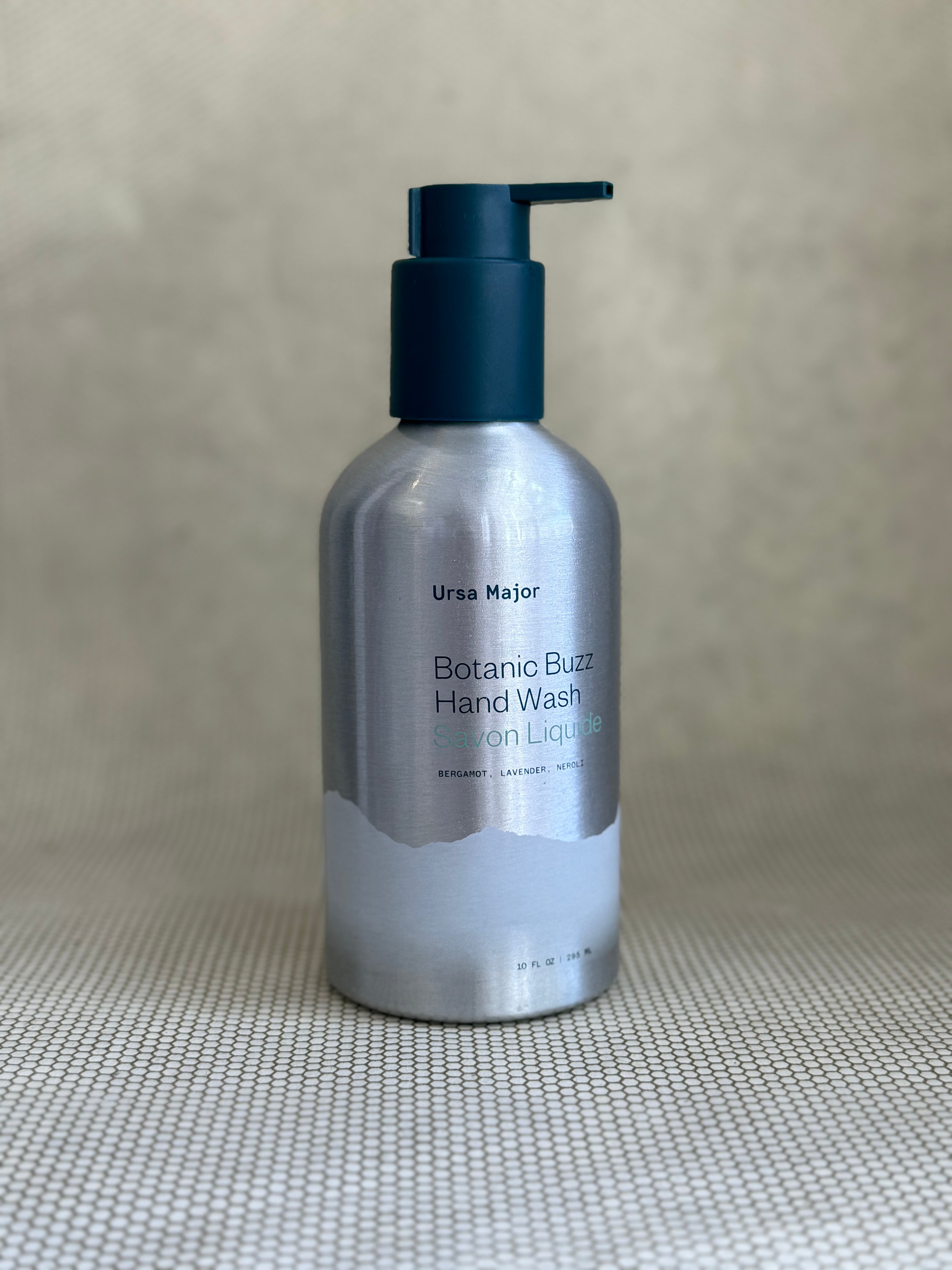 silver metallic pump bottle of Ursa Major Botanic Buzz Hand Wash