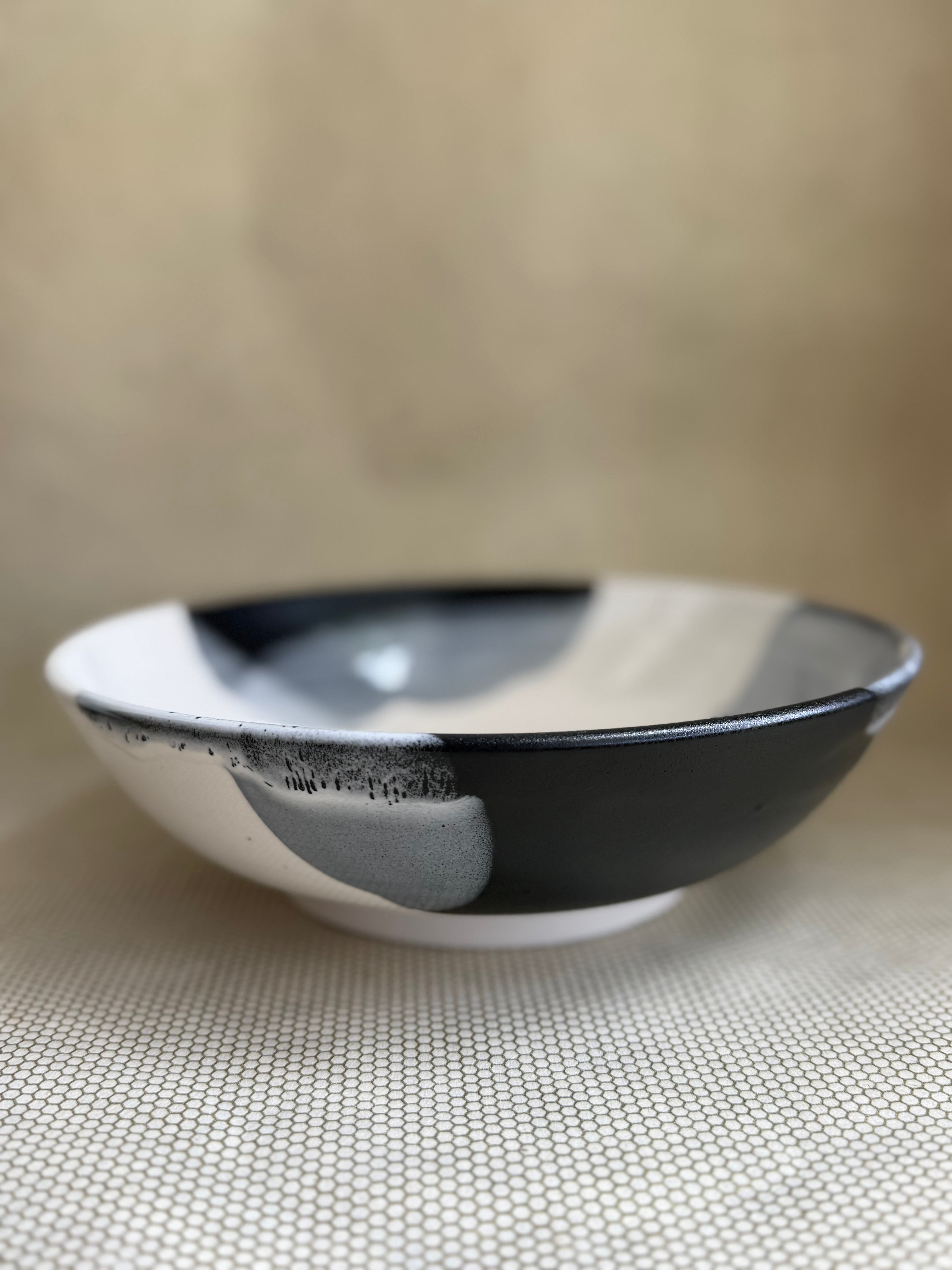 Black and white ceramic bowl on a neutral surface.