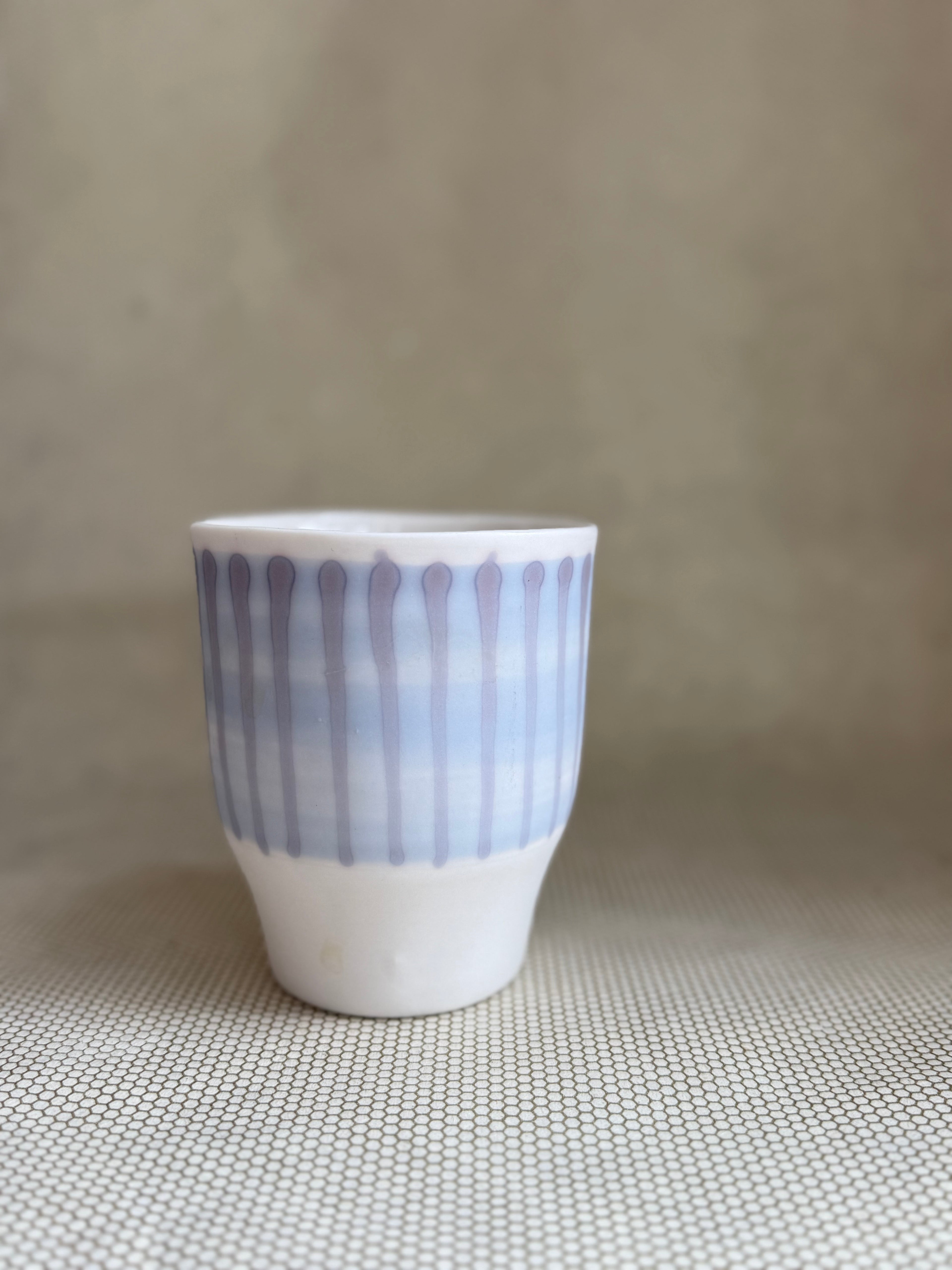 lavender and blue porcelain handcrafted tumbler on neutral background 