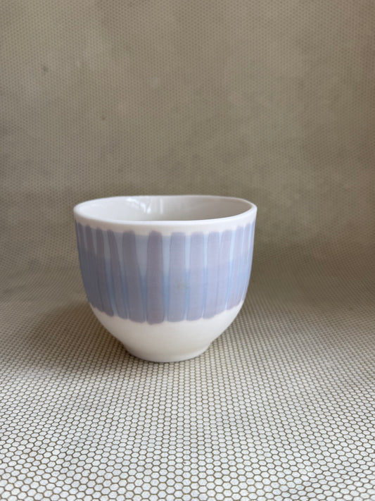 lavender and blue porcelain handcrafted latte cup on neutral background. 