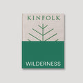 The cover of the book 'Kinfolk Wilderness', featuring a minimalist design with a green and white color scheme and a stylized tree graphic.