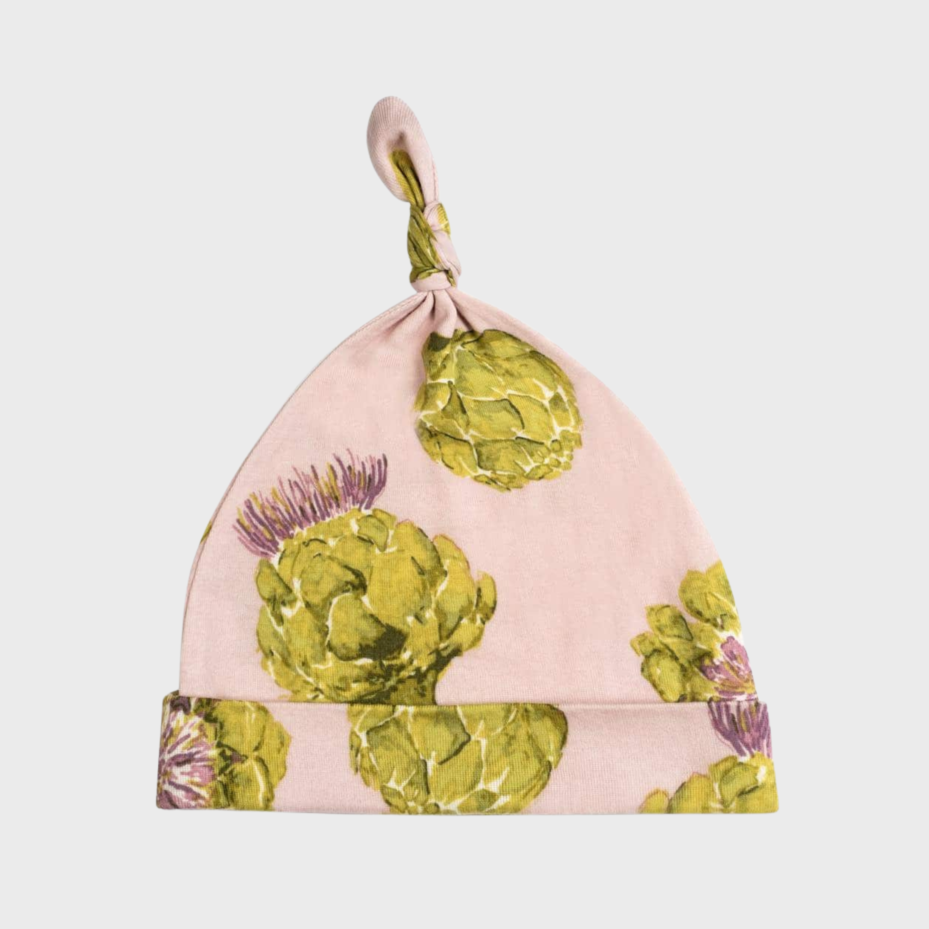 Organic cotton knotted baby hat with an artichoke print on a pink background.