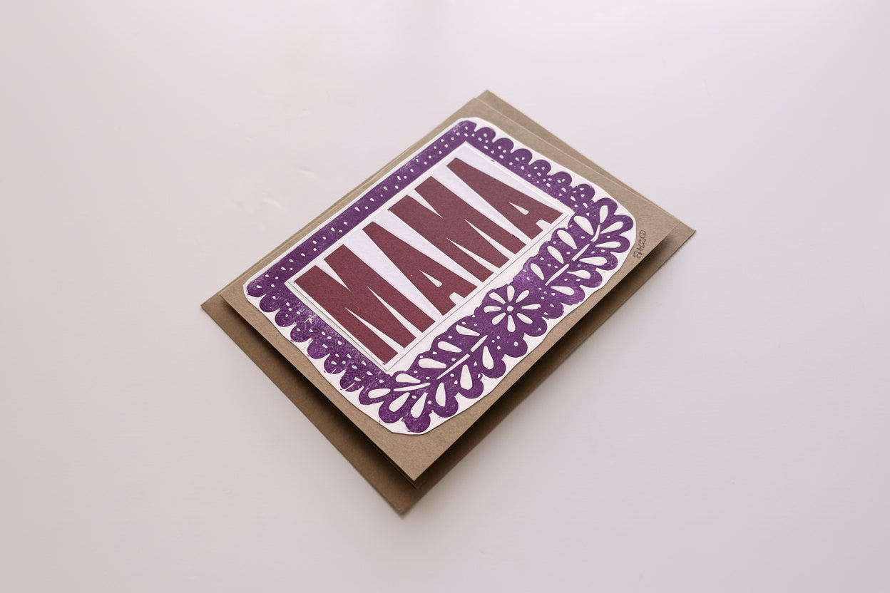 Card with 'MAMA' in purple on a brown envelope against a white background